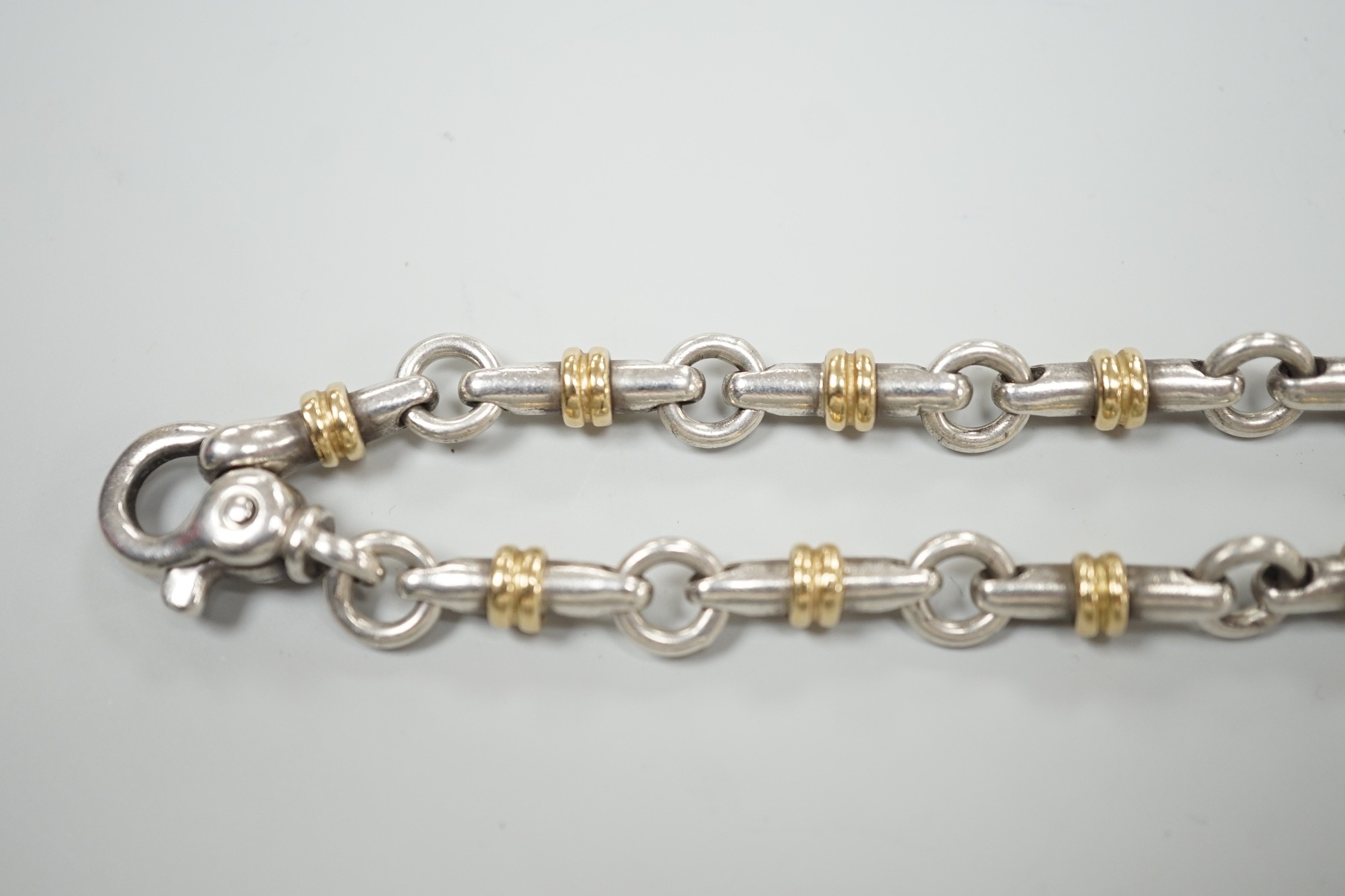 A modern Italian Tiffany & Co 750 yellow metal and 925 white metal, circular and baton link bracelet, 18cm.